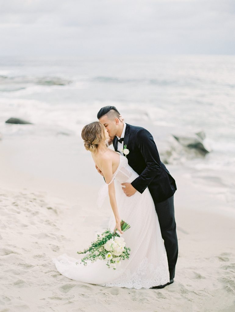 Darlington House in La Jolla wedding bride and groom kissing on beach photo