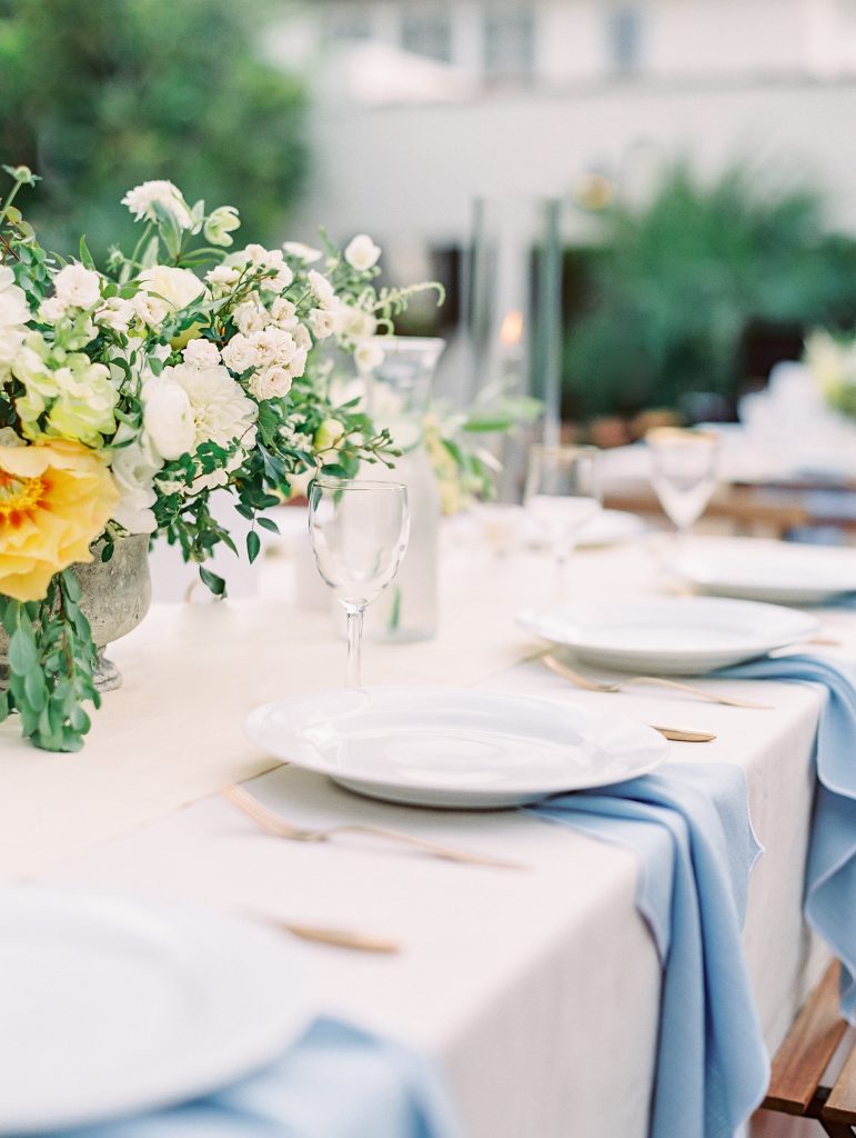 Darlington House in La Jolla wedding reception table blue napkins and yellow flowers photo