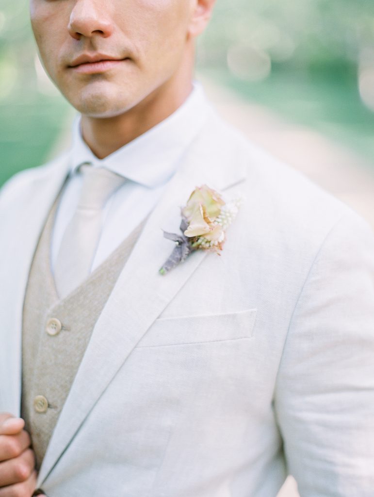 Kestrel Park in Santa Ynez wedding groom in white linen suit with boutonnière great gatsby outfitphoto
