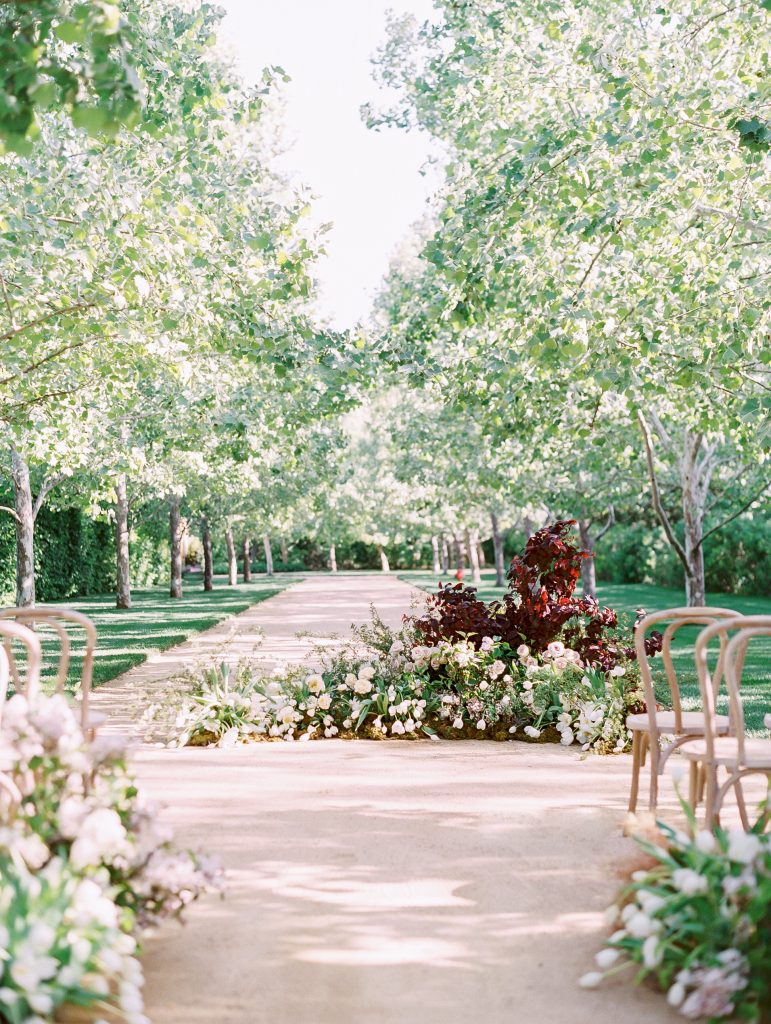 Kestrel Park in Santa Ynez wedding ceremony decor wood chairs and wild flowers photo